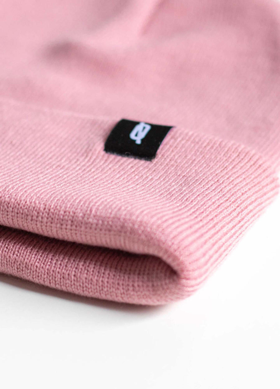 Close up of dusky pink snowboard beany